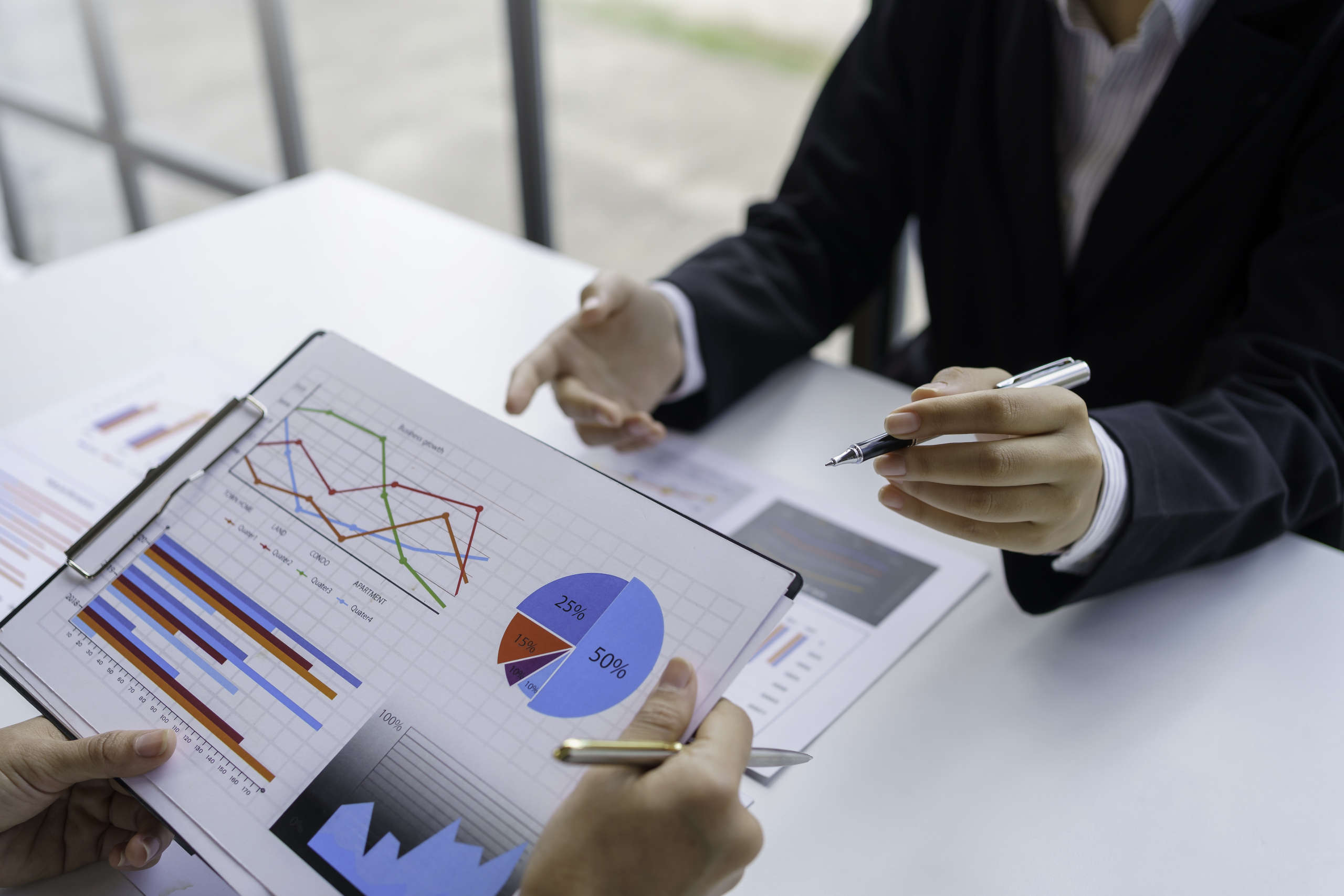 Business people consulting and planning work, looking at chart g